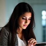 Photo of Aisha Khan looking at a tablet